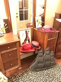 another view of the dressing table or vanity with  great hats and a metal ship wall hanging