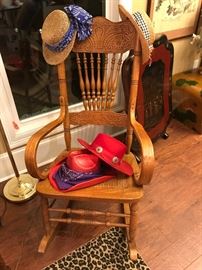 Oak rocker with bow arms in excellent condition. Check out the straw hats and the red hats 