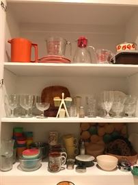 vintage tupperware and neat glasses along with other items stored nicely and waiting for a home