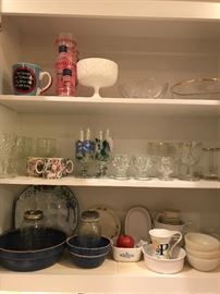 another view of the kitchen cabinets. clean and neat. vintage and antique to every day items. antique crock ware along side corning ware make this a great shopping event