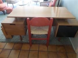 Mid-Century teak 2 sided desk with floating top,. Two drawers at left, one at right, backside has bookshelf.