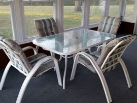 Glass top patio table and 4 cushioned chairs