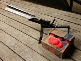 Clay pigeon thrower and box of clay pigeons