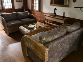Wicker love seats and glass top tables