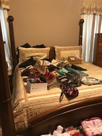 Master Bedroom - bedding and poster bed available. Purses on bed.