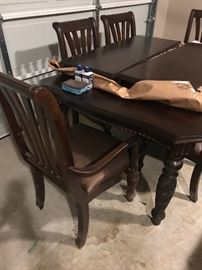 Garage - another view of table and chairs - 2 leaves on top of table