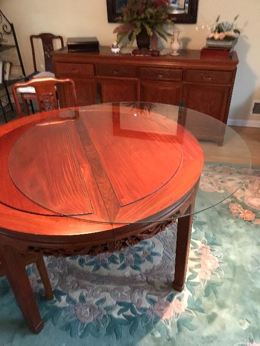 Rosewood Chinese dining room  Set: includes 2 armchairs, 6 chairs, buffet, 2 leaves, glass top (46" round).  Table without leaves 46 round, with leaves 46x81" Table & buffet features carved details.