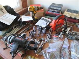 A whole kitchen table full of Craftsman tools. Plus vintage books