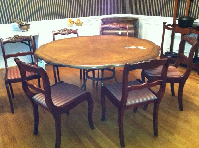 round wood table on metal base, 4 carved wood chairs