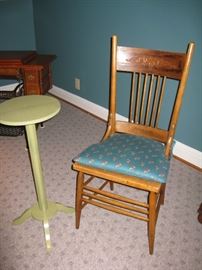 one of 2 cane bottom, spindle back chairs and green plant stand
