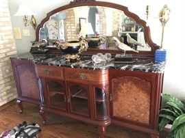 A marble-topped sideboard with all the bells, all the whistles purchased years back at Fortney's Antiques.