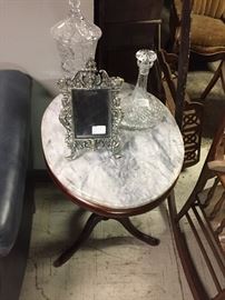 Small marble top lamp table, silverplated picture frame, Waterford ship decanter, cut crystal tall lidded compote