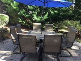 Table, chairs and umbrella.