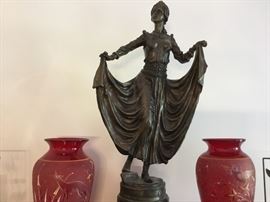 Wonderful antique lady with a pair of red blown vases; one with a deer motif, one with owls.