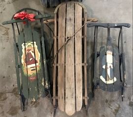 Trio of antique sleds.