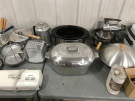 Sampling of kitchenware including heavy metal roasting pan with lid.