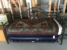 Metal day bed with mattress, bedding.