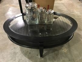 Black glass-top coffee table and canister set.