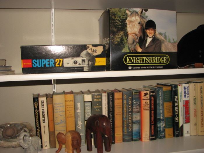 riding helmet, vintage camera, books, elephant figurines