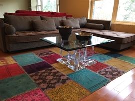 Roche Bobois Sectional, Lucite Coffee Table, Vintage Patch Work Hand Woven Rug, Michael Aram Bowl