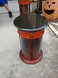 Cylinder End Table; Black Granite Top; Glass Doors; 2 Available; Sold Separately; Made by Bombay; 17"W x 17"D x 27"H; $125; ref #: 19968