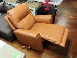 Burnt Orange Recliner; Made of Bonded Leather; Swiveling Base; Manual Recline Lever; 39"W x 42"D x 42"H; $180; ref #: 1