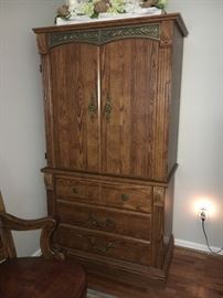 Contemporary bedroom group includes king size bed, dresser with mirror, 2 night stands and clothing armoire.