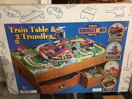 New in box Train Table with 2 trundles, includes Garage Town Train set.