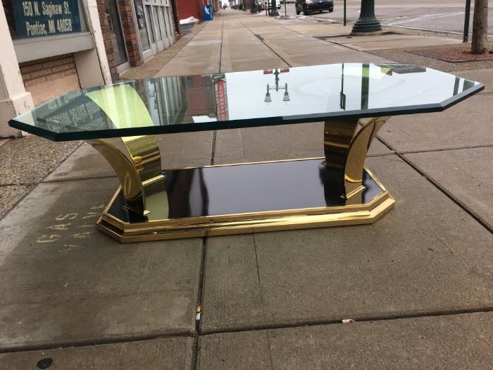 Brass & black laminate cocktail table with floating 54" inch long beveled glass top