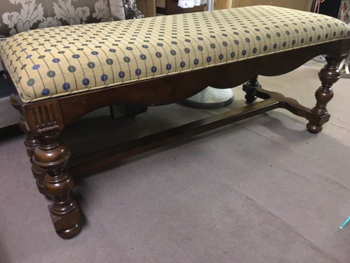 Tight top covered bench with dark brown turned legs