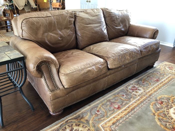 Brown leather sofa with brass nail head trim by Bradington Young, a division of Hickory Furniture of South Carolina 