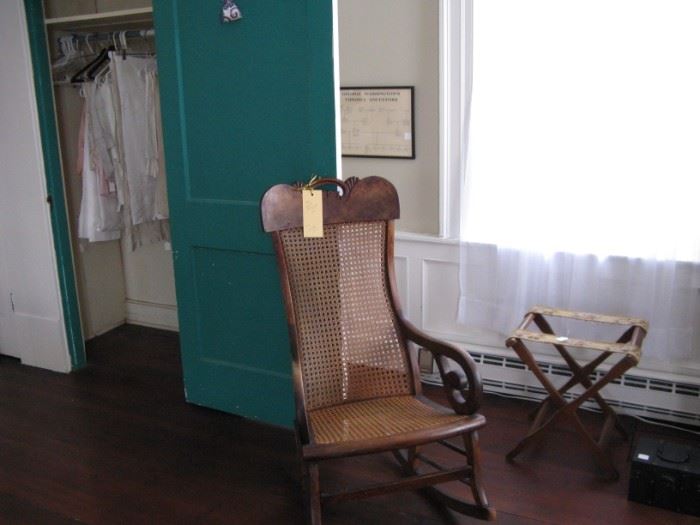           Victorian caned rocker and linens in closet