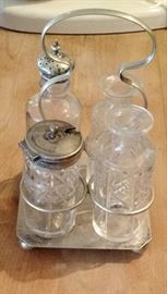 Antique Salt, Pepper, Oil, and Vinegar Set nested together in this aluminum caddy. Very unusual set.
