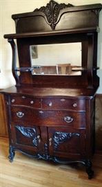 Antique Sideboard from Signal Mountain with Beveled Mirror and lower cabinets for ease of storing fine linens, drawers for fine silver and top for showcasing those precious heirlooms. Dimensions 76”H x 51” W x 19’ D. Beautiful Piece.