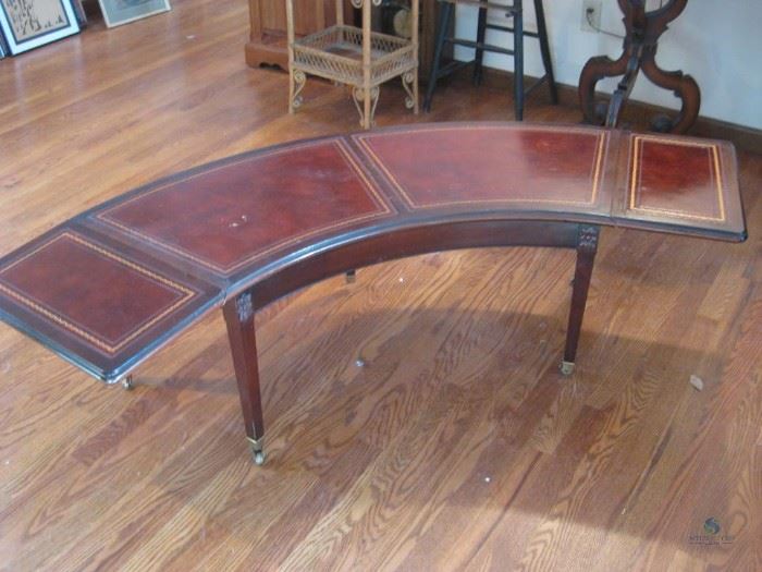 Curved drop leaf bench with brass wheels