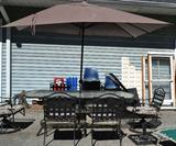 Patio set with umbrella and six chairs.