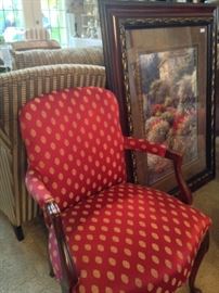 One of two matching arm chairs; framed art