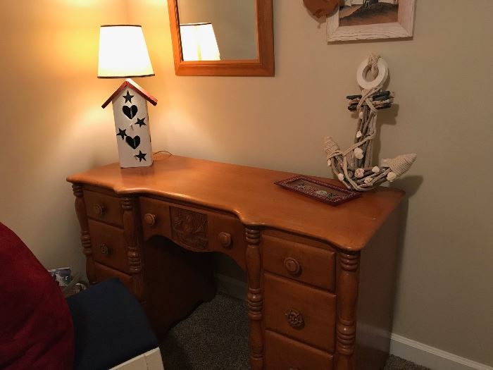 Unique desk with ship carving on drawer