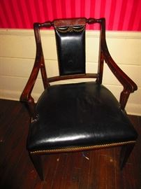 Antique armchair wearing black leather