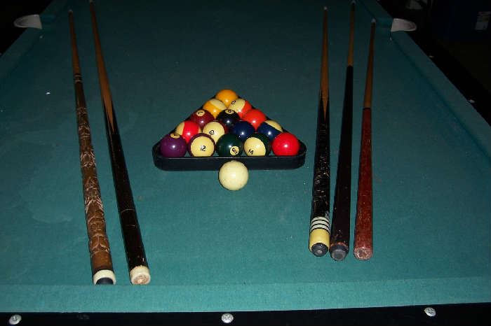 Cues, rack and balls included with pool table