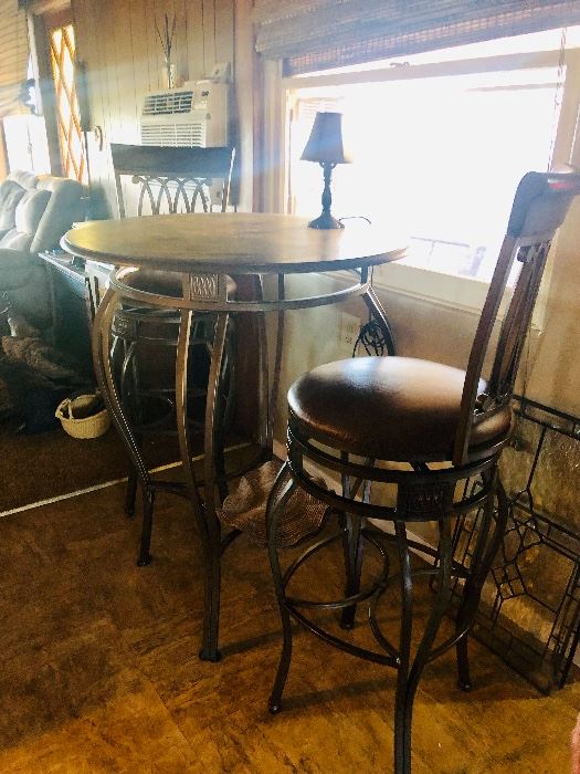 Pub table with iron base and iron barstools