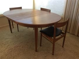 Mid-century Danish teak dining table - 48" round. Has three 20" leaves (one leaf in place in photo) Extends to 9 ft. long with all leaves in place. Purchased new in 1965.