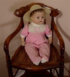 Collectible vintage doll and chair.