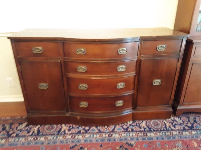 Duncan Phyfe, solid mahogany buffet in good condition. Lots of great storage. Quite heavy.  Picture doesn't do it justice.  The color is a deep, rich burgundy, not brown.