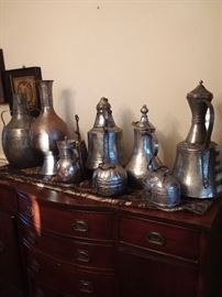Large and small copper pots.  Soap boxes, water pitchers, oil pitchers, coffee pot, camel bell in the back with the handle.  So beautiful with the tin overlay!  All are a must see!