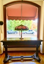 Handel Lamp with Leaded Glass Shade (small repair) on trailing vine edge carved Library Table, in the Gothic Style