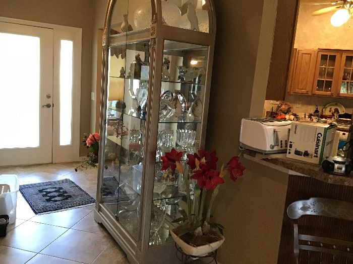 Howard Miller Display Cabinet. This is a beautiful piece. Finish is silver/metallic. Mirrored back