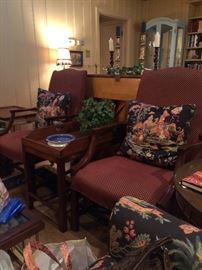 Two matching red/gold fabric arm chairs and handsome antique side table