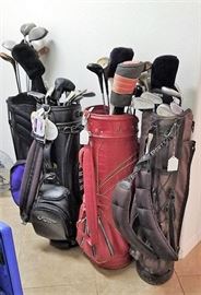 Lots of golf clubs and bags. More also available .