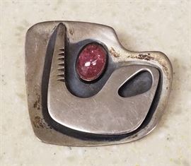 Sterling silver brooch set with semi-precious purple stone by Ed Weiner (1918-1991). Ed Weiner was one of the most talented and respected modernist jewelry designers of the early years of the New York wearable art movement. Though almost entirely self taught, he possessed a fine appreciation of form, line, and color. Most of his work, like this piece, was in silver. I have not polished it.